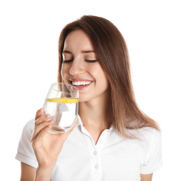 Young woman drinking lemon water on white background