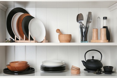 White shelving unit with set of dishware