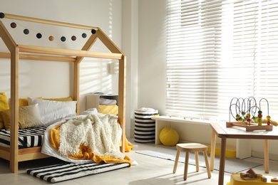 Photo of Cozy child room interior with comfortable bed