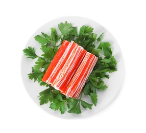 Photo of Plate with crab sticks and parsley on white background, top view
