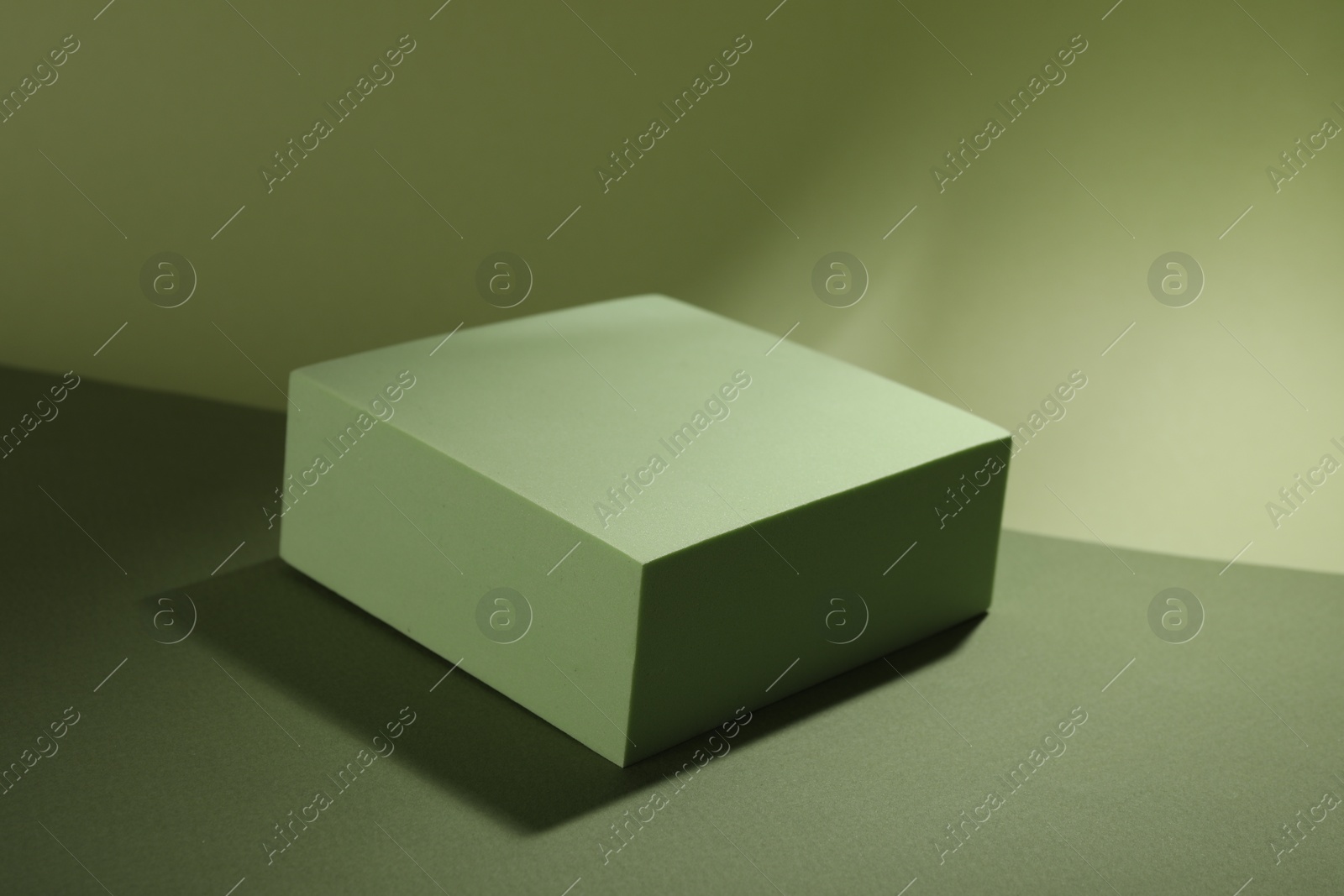 Photo of Presentation of product. Podium and shadows on light green background. Space for text