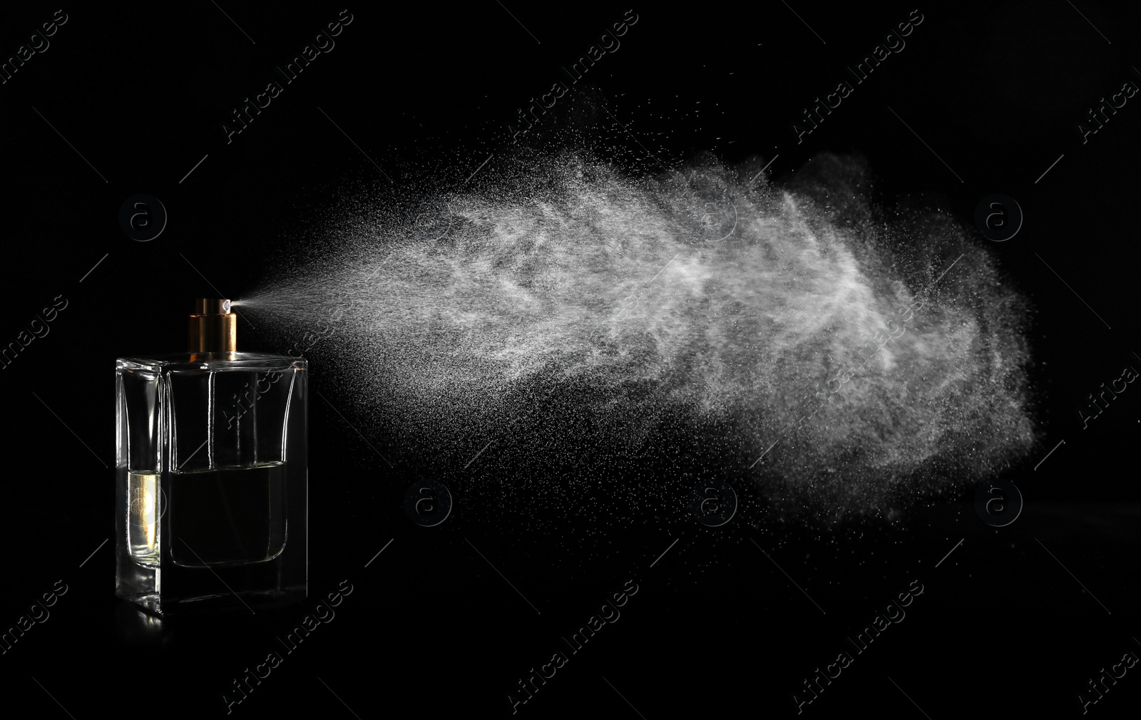 Photo of Woman spraying luxury perfume on black background, closeup