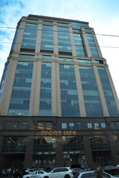 Photo of KYIV, UKRAINE - MAY 23, 2019: Modern business center SENATOR and cars on city street