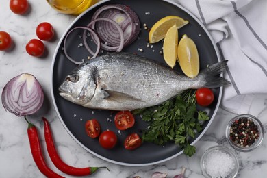 Fresh dorado fish and ingredients on white marble table, flat lay