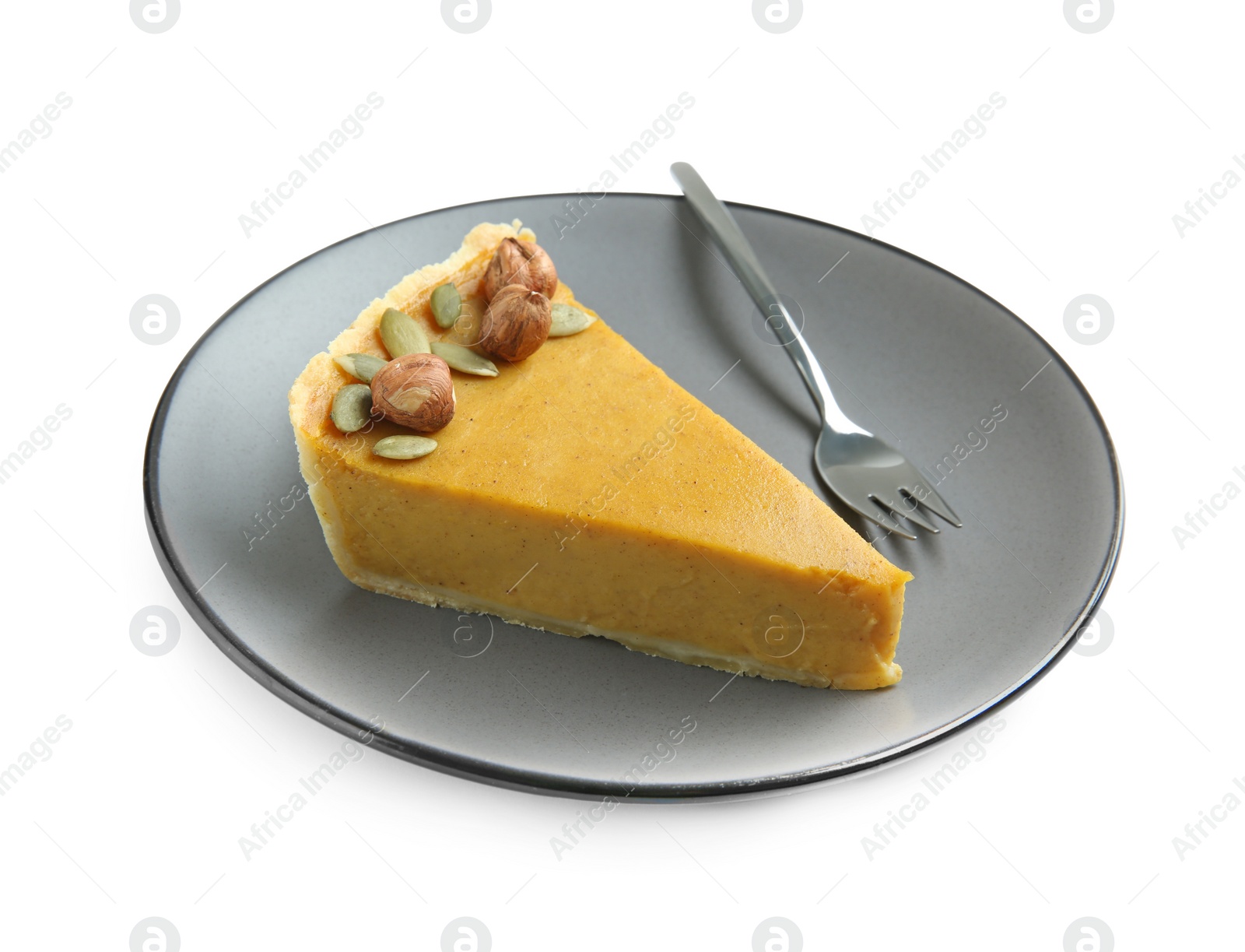 Photo of Piece of delicious pie with hazelnuts, pumpkin seeds and fork isolated on white