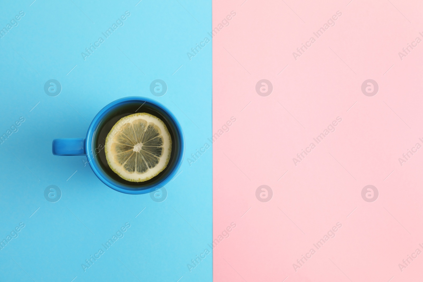 Photo of Cup of tea on color background, top view. Space for text