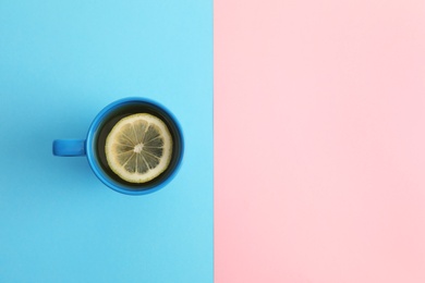 Photo of Cup of tea on color background, top view. Space for text