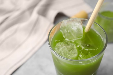 Photo of Glass of delicious iced green matcha tea, closeup. Space for text