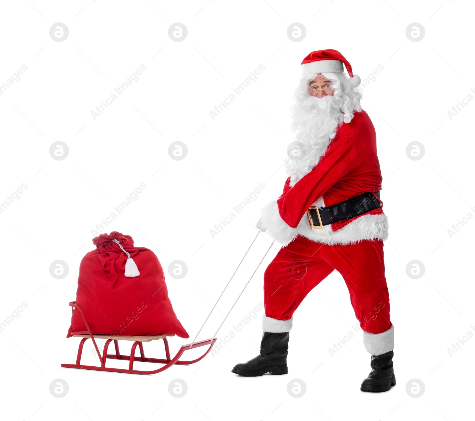 Photo of Man in Santa Claus costume with bag and sleigh on white background