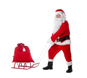 Photo of Man in Santa Claus costume with bag and sleigh on white background