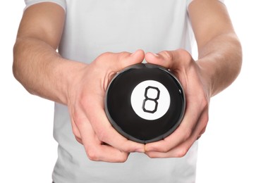 Man holding magic eight ball on white background, closeup