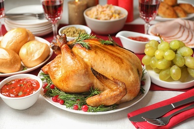 Photo of Traditional festive dinner with delicious roasted turkey served on table