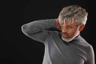 Photo of Portrait of confident man with beautiful hairstyle on black background. Space for text