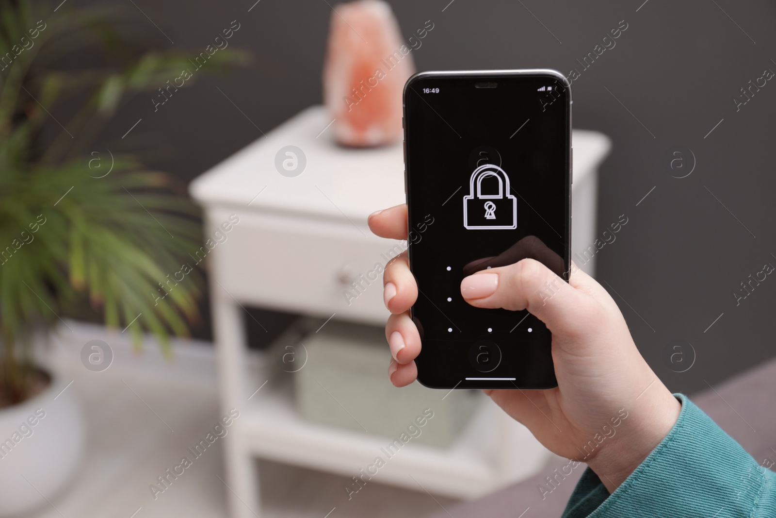 Photo of Woman unlocking smartphone with blocked screen indoors, closeup. Space for text