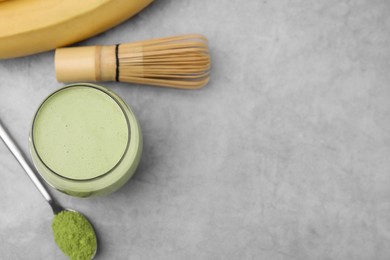 Photo of Glass of tasty matcha smoothie on light grey table, flat lay. Space for text