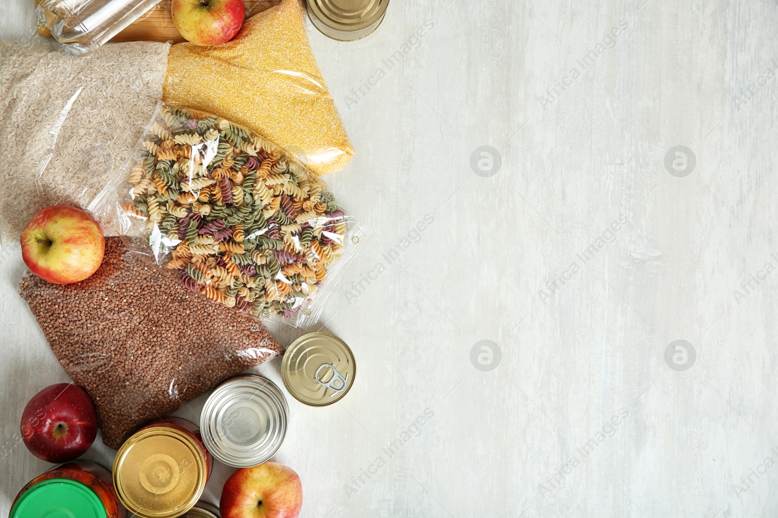 Photo of Many different products and space for text on white wooden background, flat lay. Food donation