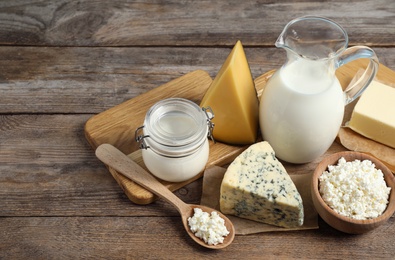 Different delicious dairy products on wooden table