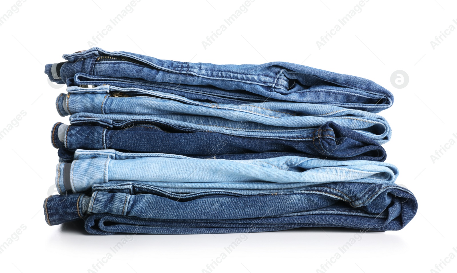 Photo of Stack of stylish jeans on white background