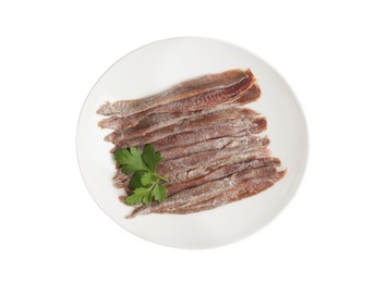 Plate with anchovy fillets and parsley on white background, top view