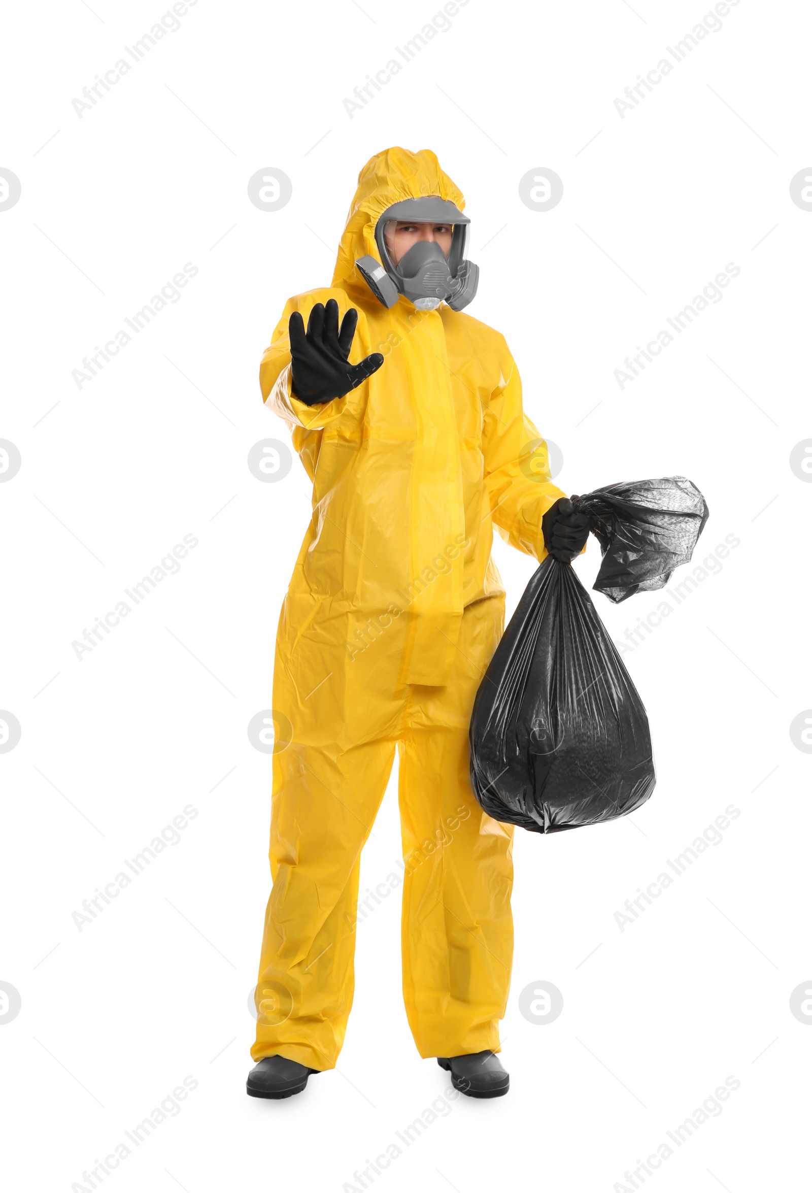 Photo of Man in chemical protective suit holding trash bag on white background. Virus research