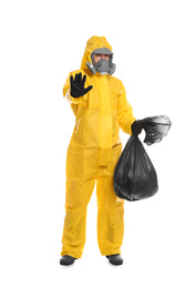 Man in chemical protective suit holding trash bag on white background. Virus research