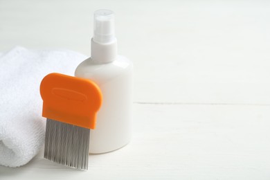 Photo of Comb, anti lice spray and towel on white table. Space for text