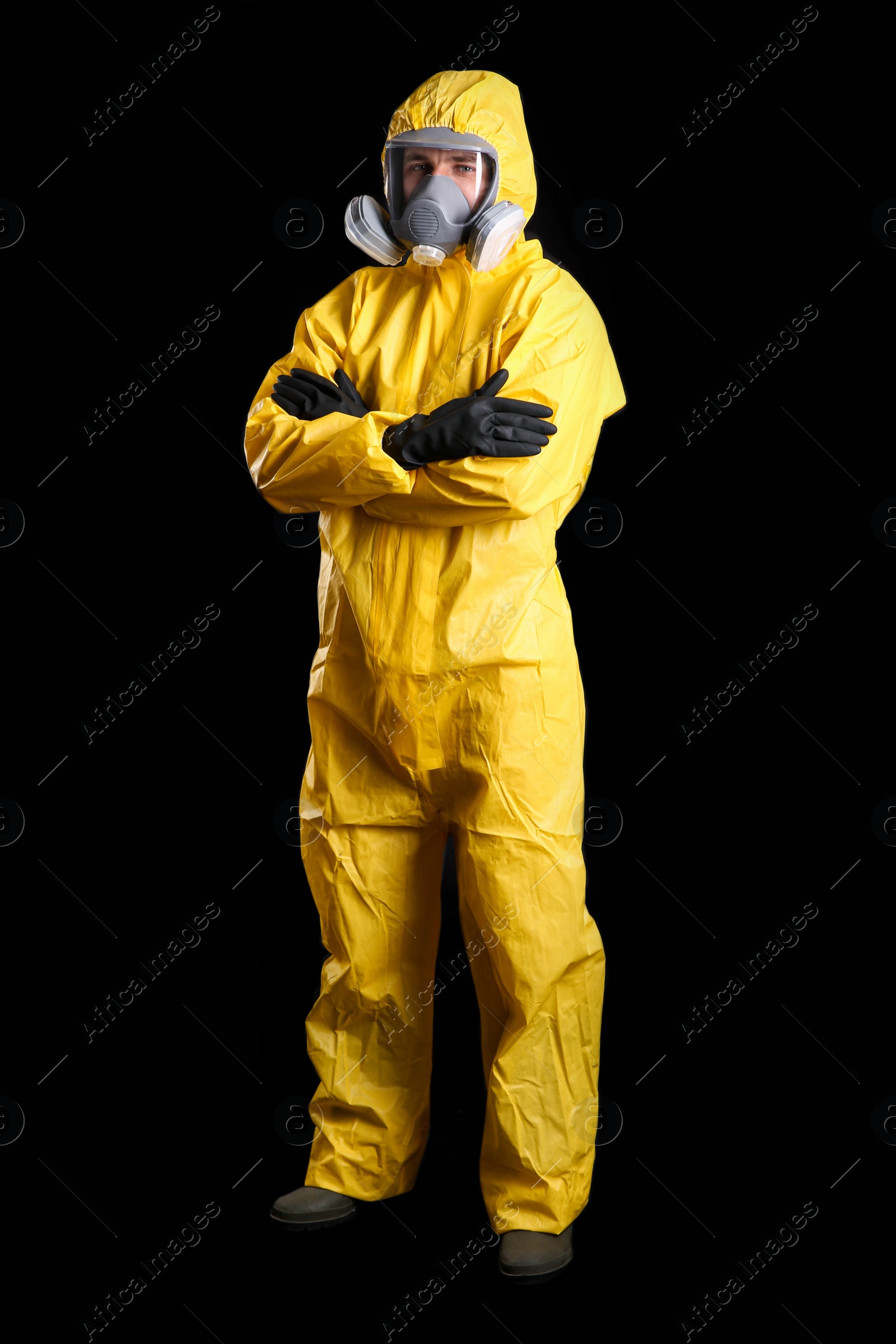 Photo of Man wearing chemical protective suit on black background. Virus research