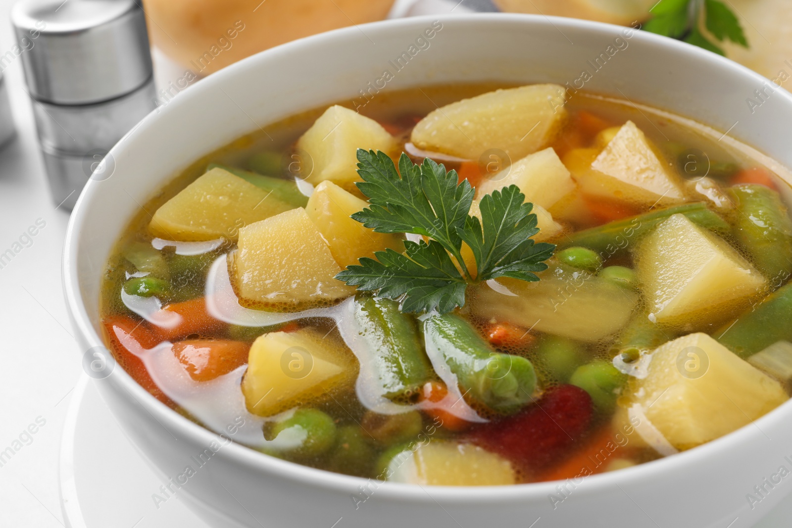 Photo of Bowl of delicious turnip soup on table, closeup