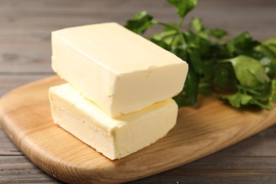 Photo of Tasty butter and parsley on wooden table, closeup