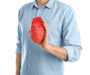 Photo of Man holding model of heart on white background. Heart attack concept