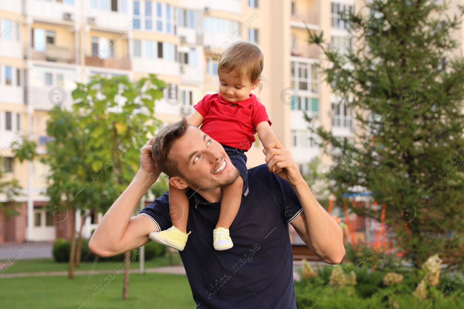 Photo of Father with adorable little baby outdoors. Happy family