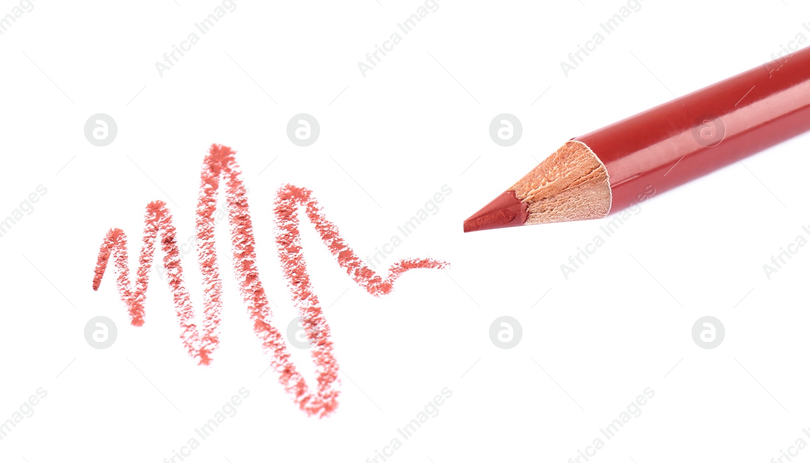 Photo of Bright lip liner stroke and pencil on white background