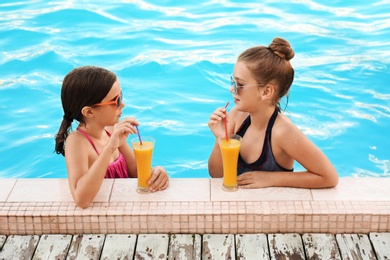 Photo of Happy girls with drinks in swimming pool
