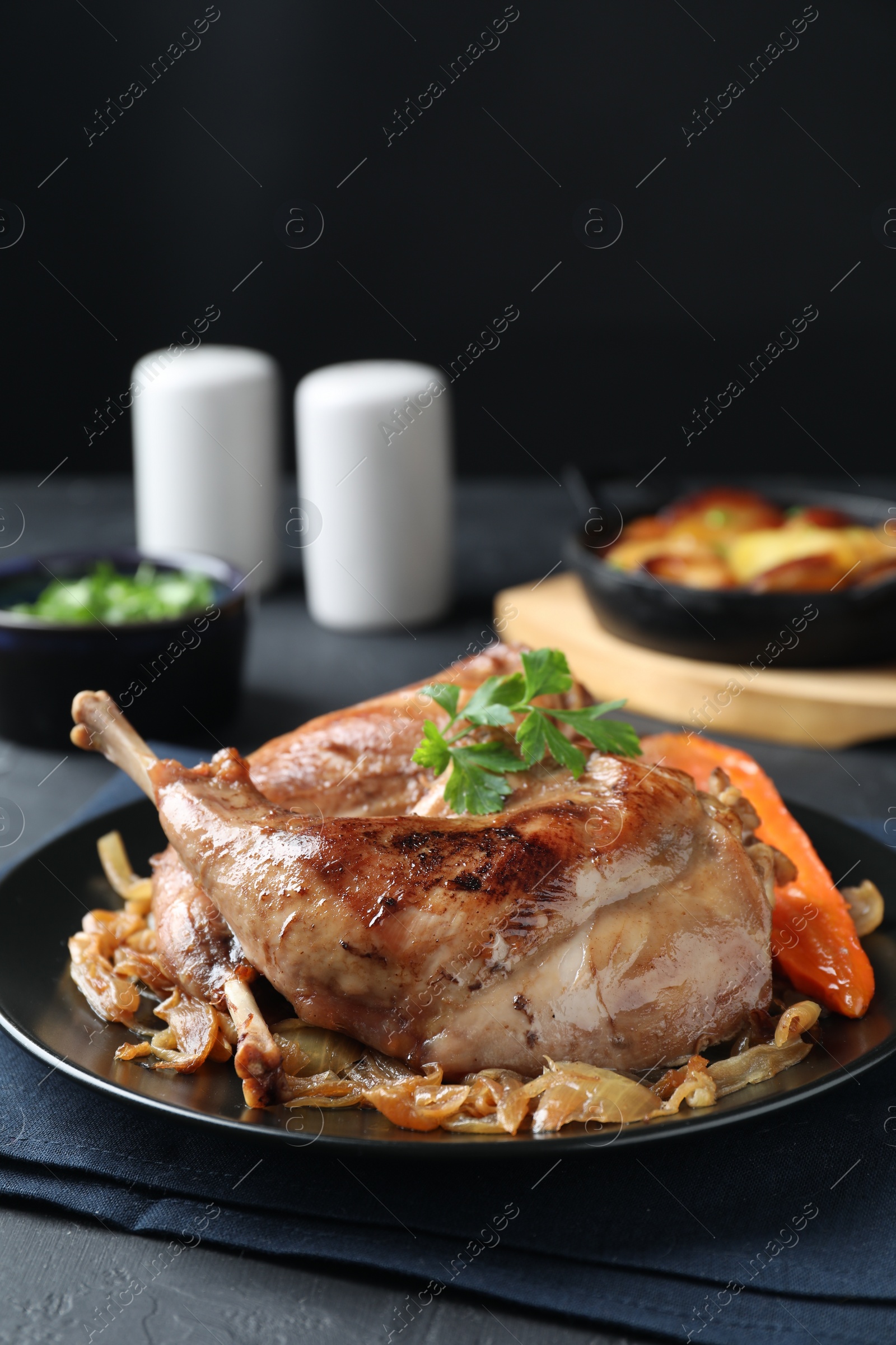 Photo of Tasty cooked rabbit meat with vegetables served on table