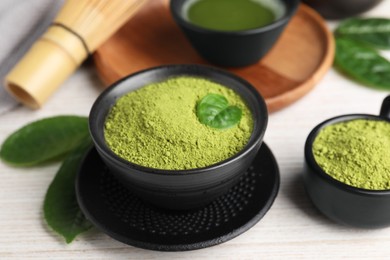 Photo of Green matcha powder on white wooden table, closeup
