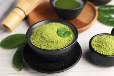 Green matcha powder on white wooden table, closeup