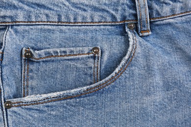 Light blue jeans with inset pocket as background, closeup