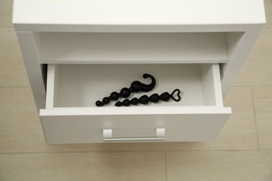 Black anal beads in drawer indoors. Sex toys