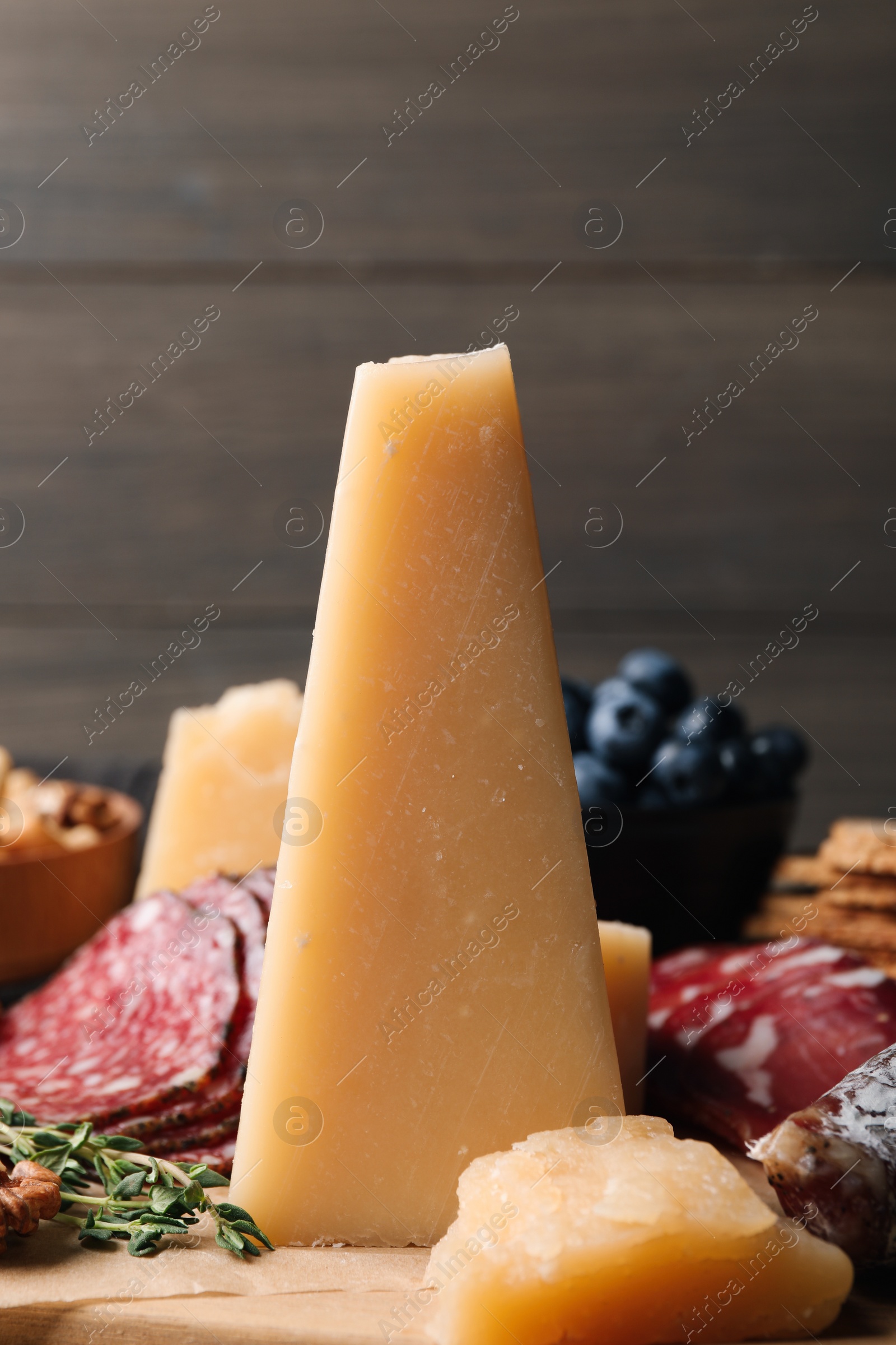 Photo of Piece of parmesan cheese on snack platter, closeup