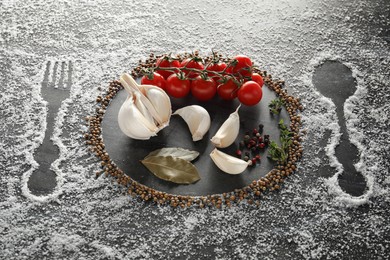 Photo of Different spices and silhouettes of cutlery and plate on grey marble background