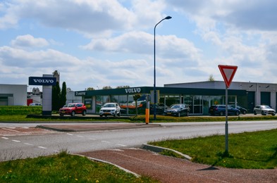 Photo of VEENDAM, NETHERLANDS - APRIL 26, 2022: Volvo car dealership near road on sunny day