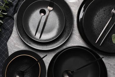 Photo of Stylish table setting with cutlery on grey surface, flat lay