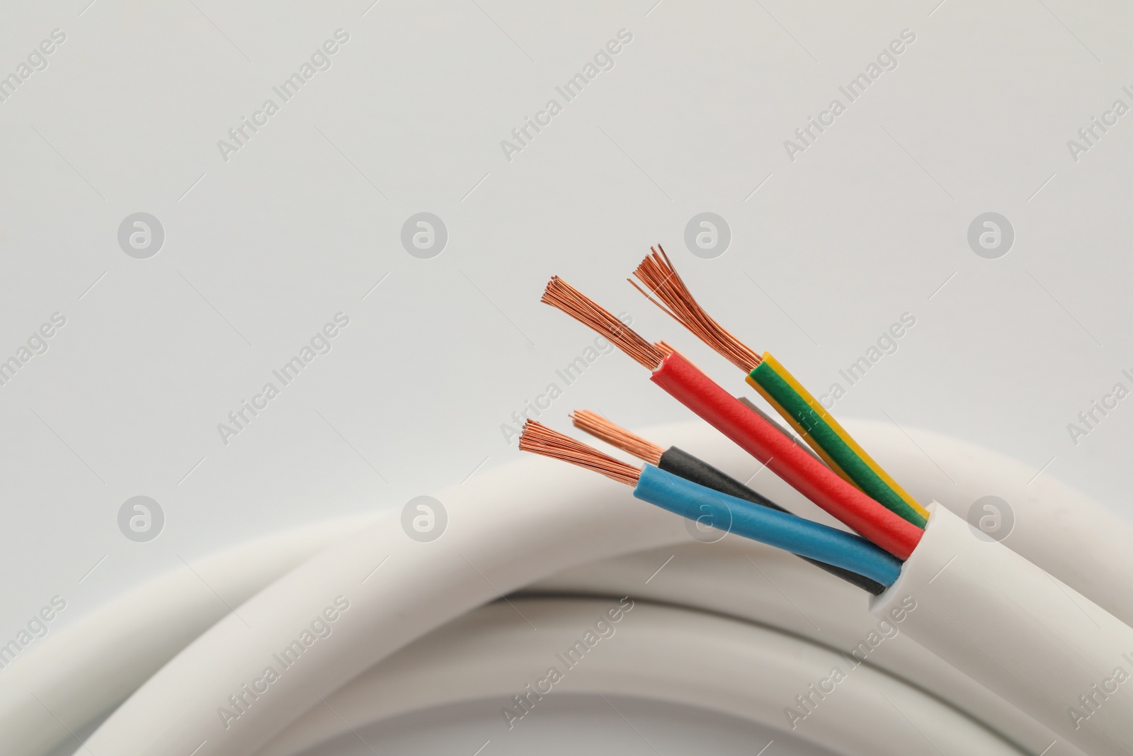 Photo of Electrical wires on white background, closeup view