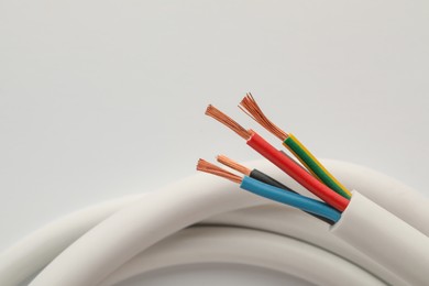 Photo of Electrical wires on white background, closeup view