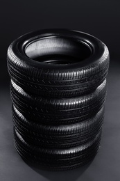 Stack of car tires on black background