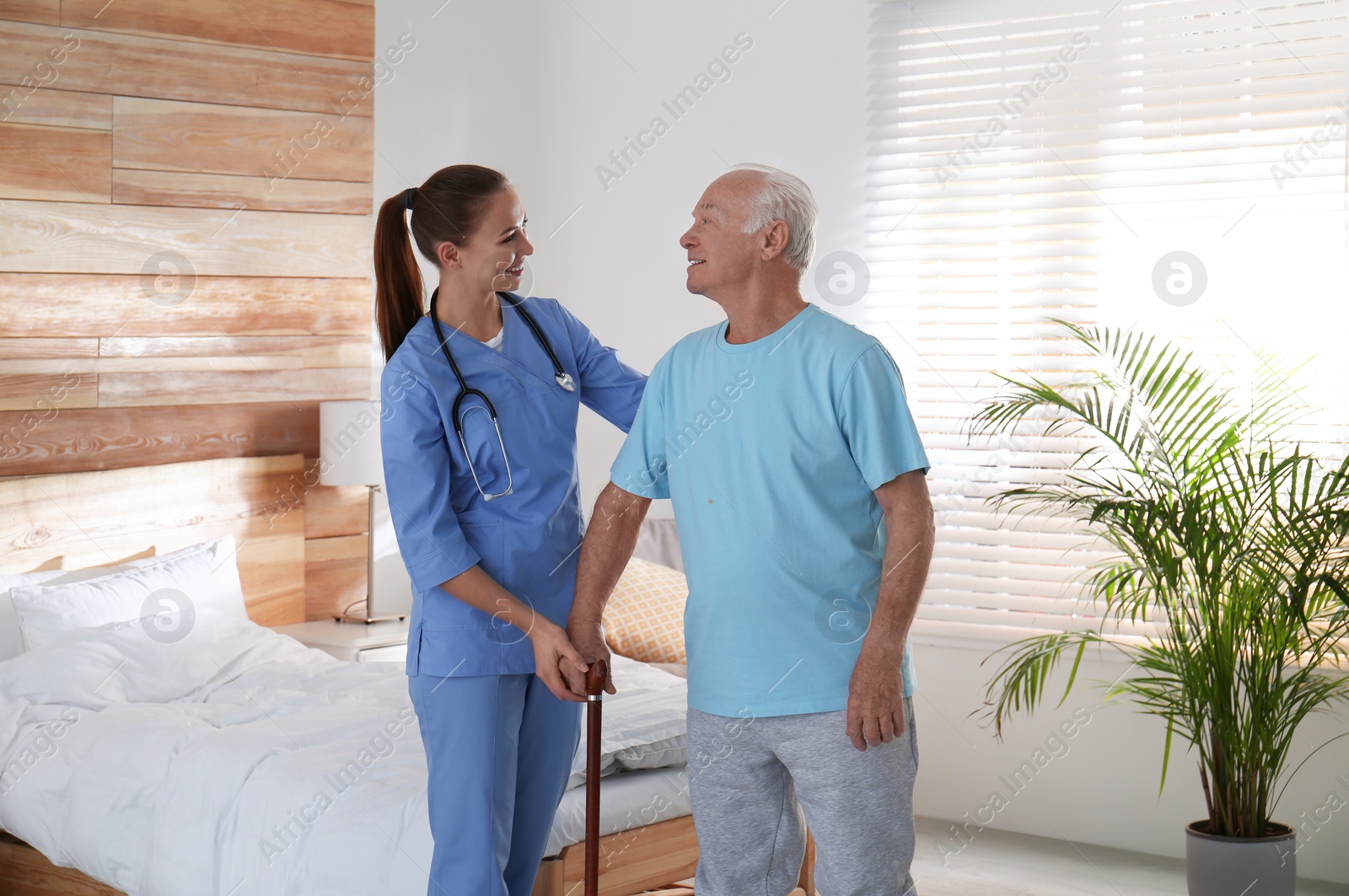 Photo of Doctor with senior patient in modern hospital