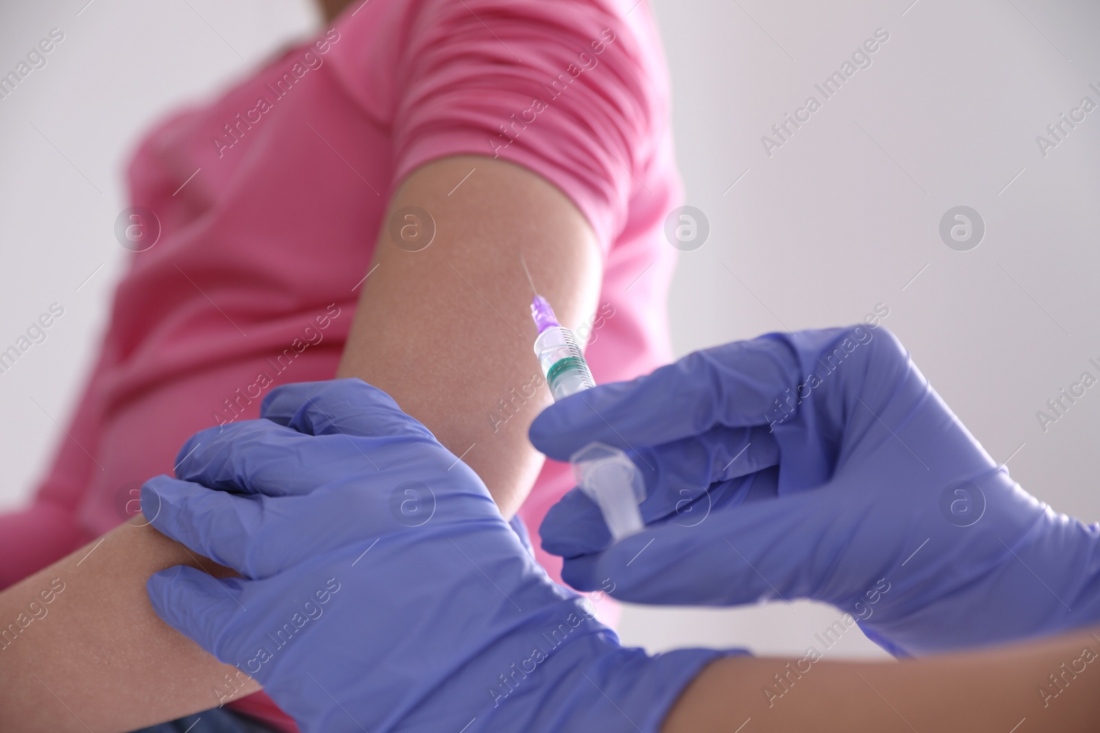 Photo of Little girl receiving chickenpox vaccination in clinic, closeup. Varicella virus prevention