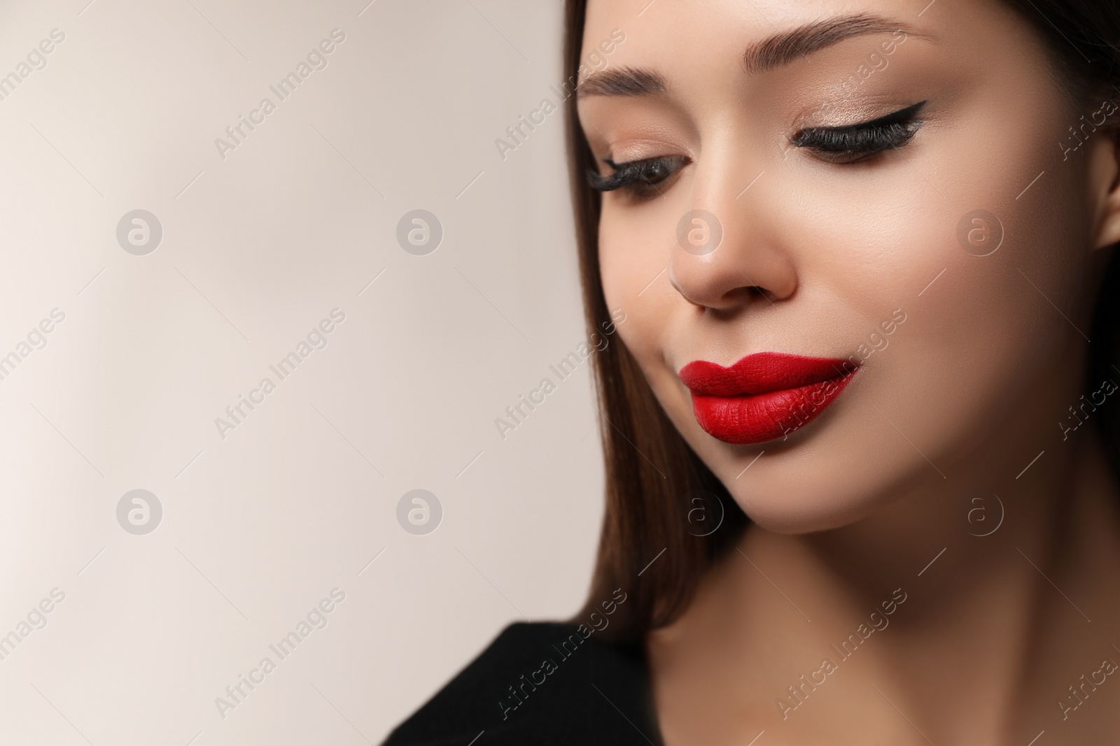 Photo of Beautiful woman with red lipstick on light background, space for text