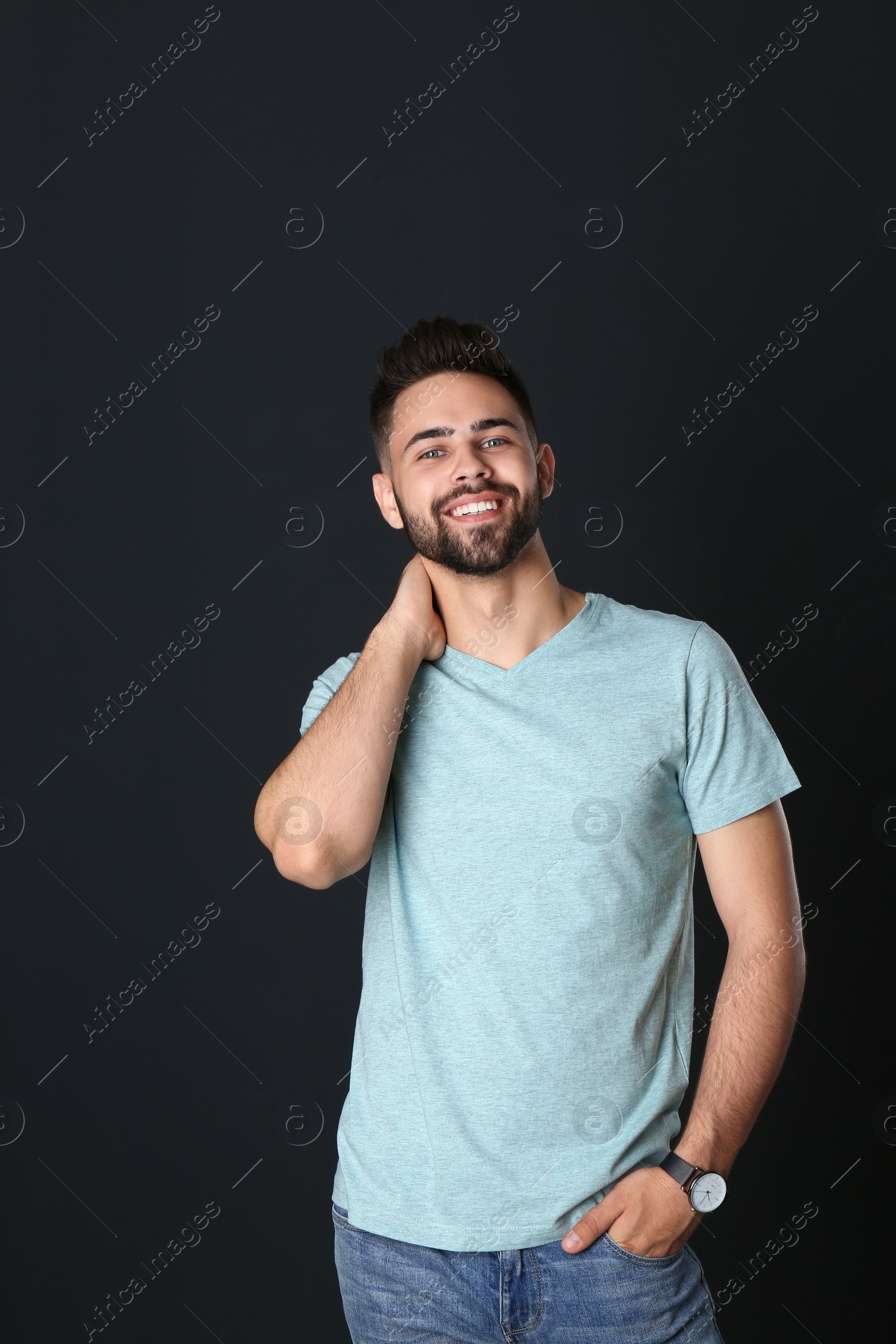 Photo of Portrait of handsome smiling man on black background