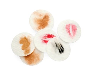 Photo of Dirty cotton pads after removing makeup on white background, flat lay